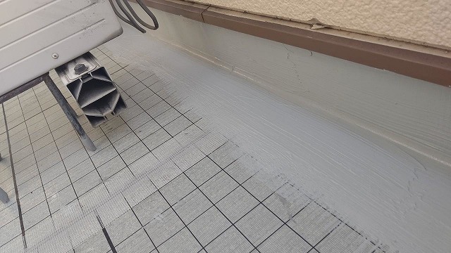 名東区で雨漏りが生じたベランダへウレタン防水工事、通気緩衝工法でローラーで施工を完了していく様子